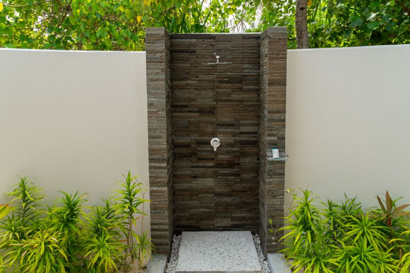 Open Shower with Stone Tile Walls
